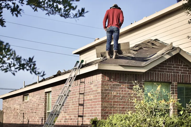 Professional roofer working on a residential roof in Rock Lake